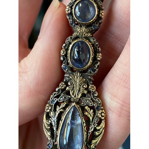 32 - A pair of 19th century gold and silver lorgnettes, of pierced foliate form, bezel set with three sap... 