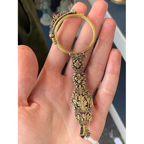 32 - A pair of 19th century gold and silver lorgnettes, of pierced foliate form, bezel set with three sap... 
