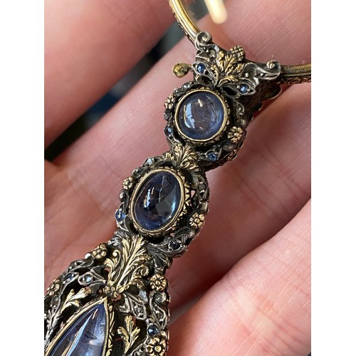 32 - A pair of 19th century gold and silver lorgnettes, of pierced foliate form, bezel set with three sap... 