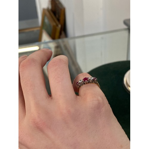 6 - An early 20th century 18ct gold, ruby and diamond five stone ring, the largest ruby 4.5mm diameter, ... 