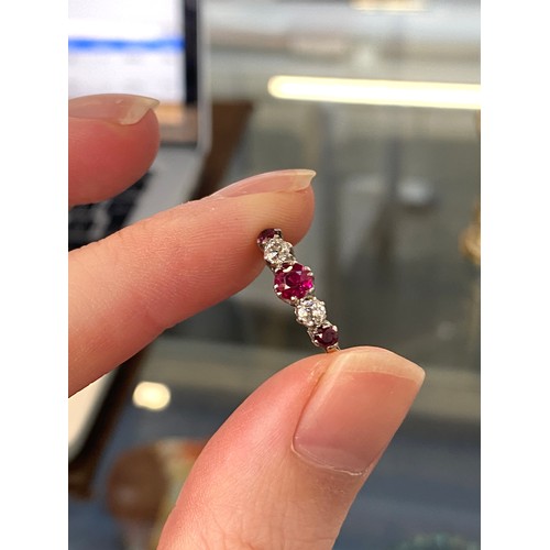6 - An early 20th century 18ct gold, ruby and diamond five stone ring, the largest ruby 4.5mm diameter, ... 