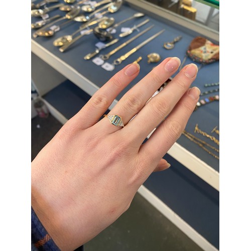 7 - An 18ct gold, aquamarine and diamond ring, the emerald cut aquamarine approx. 0.63ct, flanked by thr... 