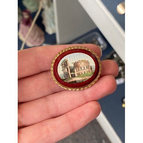 20 - A Victorian Grand Tour gold mounted double sided micromosaic brooch depicting ruins within a red bor... 