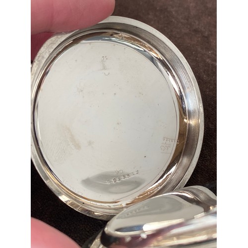 38 - A plated Goliath pocket watch, 6.2cm diameter, with a silver case, c.1900, 12cm high
