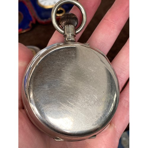 38 - A plated Goliath pocket watch, 6.2cm diameter, with a silver case, c.1900, 12cm high