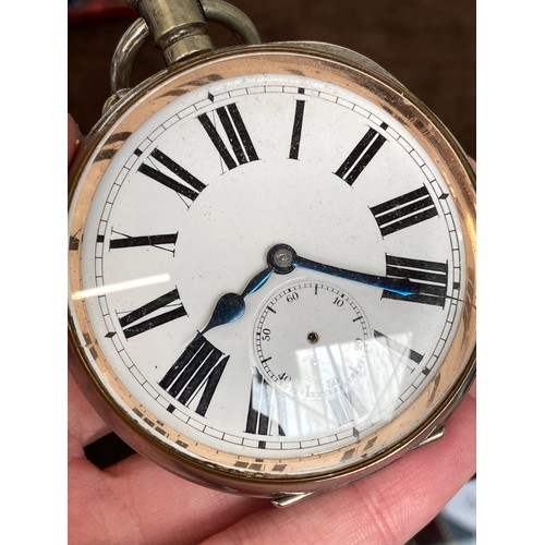 38 - A plated Goliath pocket watch, 6.2cm diameter, with a silver case, c.1900, 12cm high