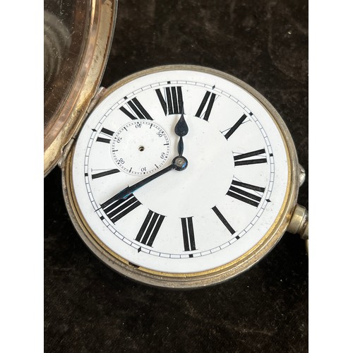 38 - A plated Goliath pocket watch, 6.2cm diameter, with a silver case, c.1900, 12cm high