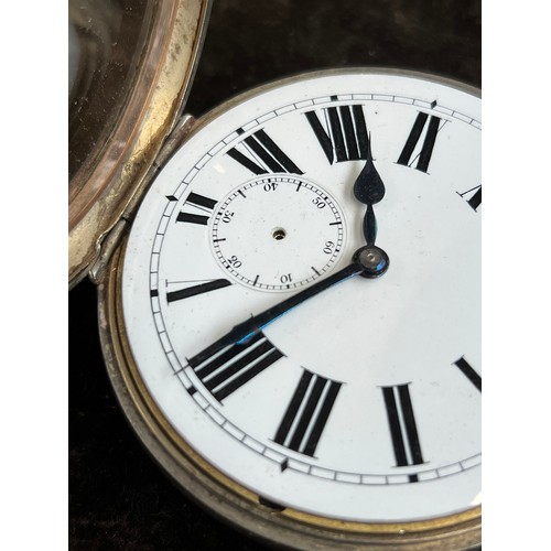 38 - A plated Goliath pocket watch, 6.2cm diameter, with a silver case, c.1900, 12cm high