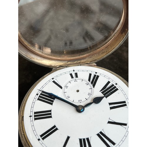 38 - A plated Goliath pocket watch, 6.2cm diameter, with a silver case, c.1900, 12cm high