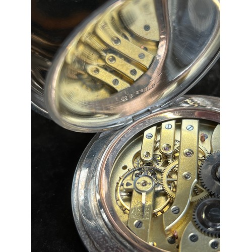 38 - A plated Goliath pocket watch, 6.2cm diameter, with a silver case, c.1900, 12cm high