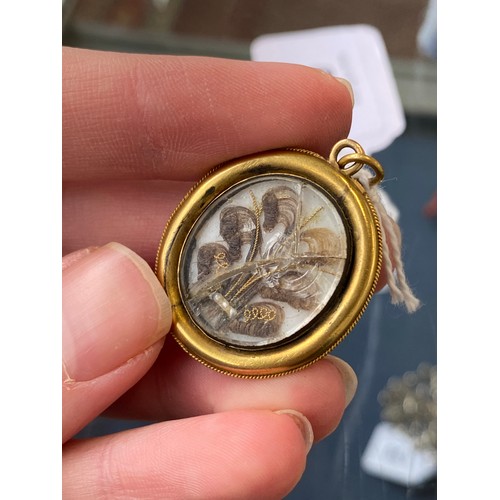 19 - A Victorian gold mounted carved shell cameo brooch depicting cupid seated, 4cm long, 8.3g; together ... 