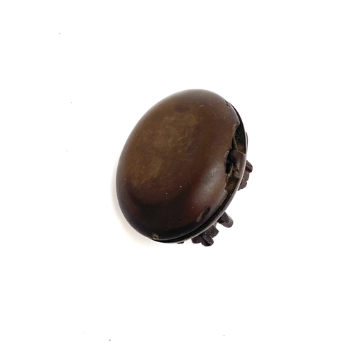 11 - A Victorian vulcanite locket, floral bouquet decoration to lid, (af), 4cmL