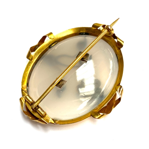 77 - A Victorian gold mounted chalcedony brooch set with a turquoise forget-me-not, tests as 15ct or high... 