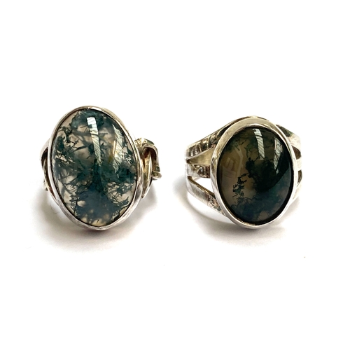 79 - Two vintage silver and moss agate cabochon rings, one with Celtic style shoulders, size M, the other... 