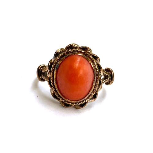 14 - A 9ct gold coral cabochon ring with ropetwist border detail, size L, 3.4g