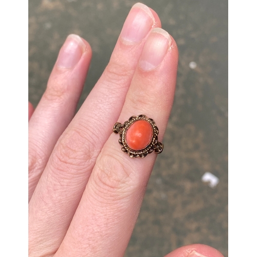 14 - A 9ct gold coral cabochon ring with ropetwist border detail, size L, 3.4g