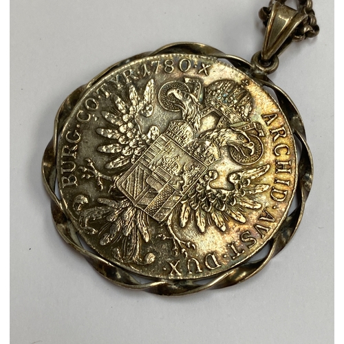 35 - An Austrian silver Thaler mounted as a pendant on a chain, 47g gross weight