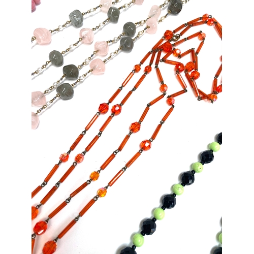 23 - A group of eight vintage beaded necklaces to include pink coral style glass beads, moulded lime gree... 