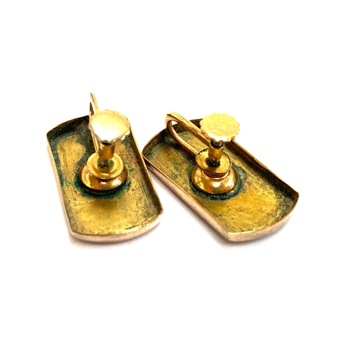 23 - A pair of gold earrings converted from a Victorian cufflink, the later gold plated screw back fittin... 