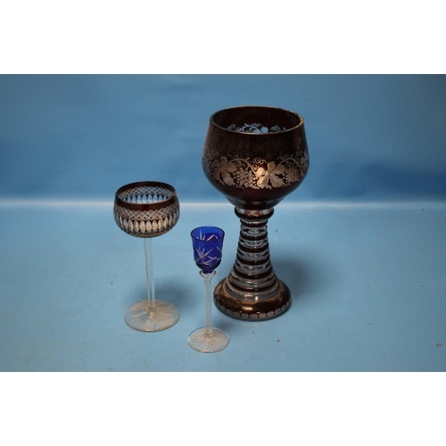 110 - A LARGE BOHEMIAN RUBY OVERLAY GLASS GOBLET WITH GRAPE AND VINE DECORATION TOGETHER WITH TWO OTHER GL... 