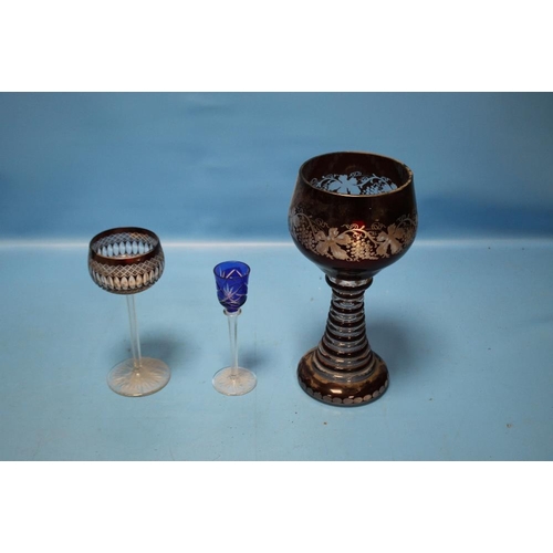 110 - A LARGE BOHEMIAN RUBY OVERLAY GLASS GOBLET WITH GRAPE AND VINE DECORATION TOGETHER WITH TWO OTHER GL... 