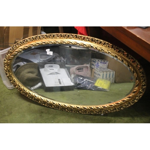 46 - AN OVAL GILT FRAMED MIRROR, 104 X 58 CM