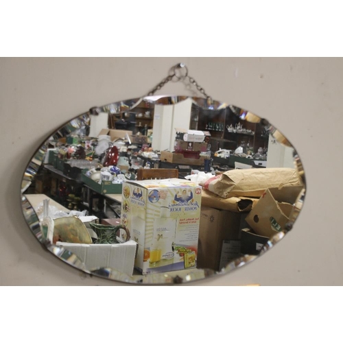 48 - AN OVAL MIRROR, 61 X 35.5 CM