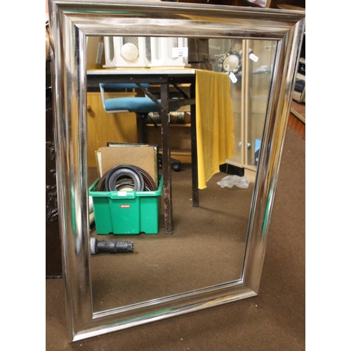 64 - A SILVER COLOURED FRAMED MIRROR TOGETHER WITH A WOODEN FRAMED MIRROR