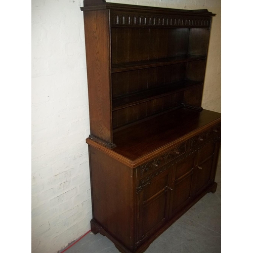 645 - AN OAK DRESSER WITH CARVED DETAILING