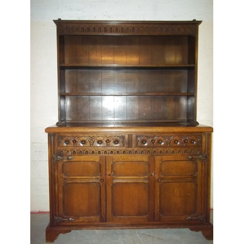 645 - AN OAK DRESSER WITH CARVED DETAILING