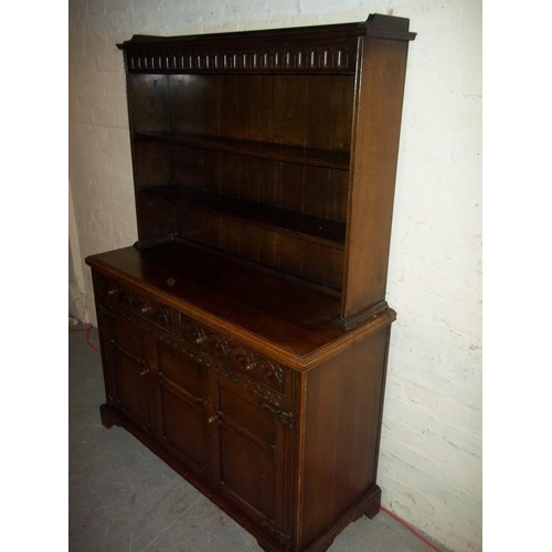 645 - AN OAK DRESSER WITH CARVED DETAILING