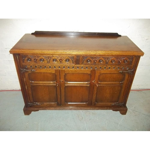 645 - AN OAK DRESSER WITH CARVED DETAILING