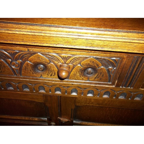 645 - AN OAK DRESSER WITH CARVED DETAILING