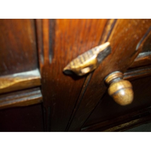 645 - AN OAK DRESSER WITH CARVED DETAILING