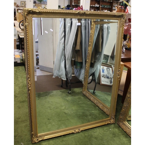 79 - A LARGE REPRODUCTION GILT FRAMED MIRROR