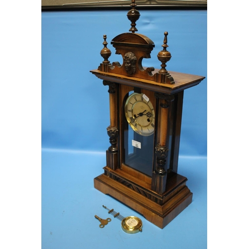 89 - AN ANTIQUE WALNUT CASED MANTEL CLOCK