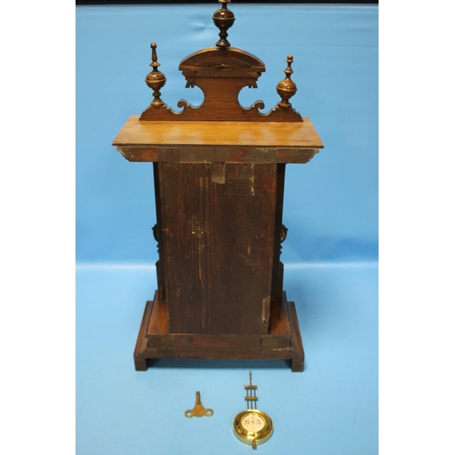 89 - AN ANTIQUE WALNUT CASED MANTEL CLOCK