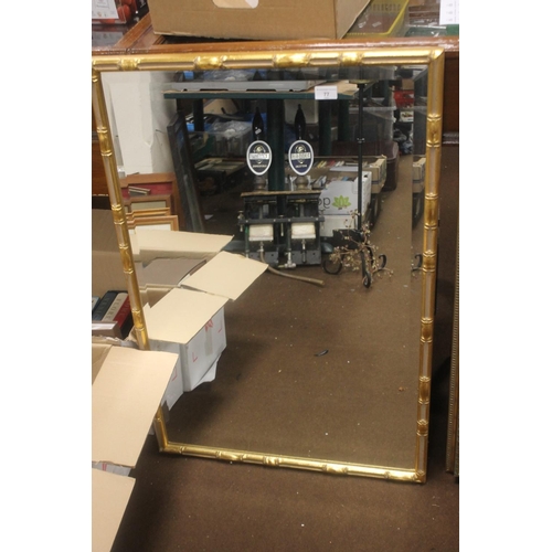 77 - A FRAMED MIRROR, 95 X 65 CM