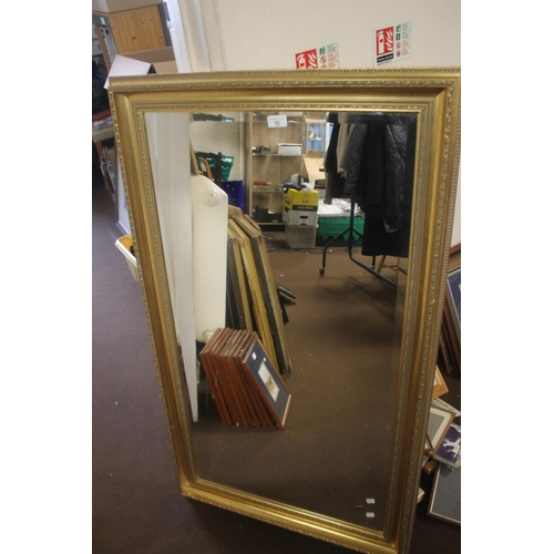 82 - A LARGE GILT FRAMED MIRROR, 130 X 75 CM