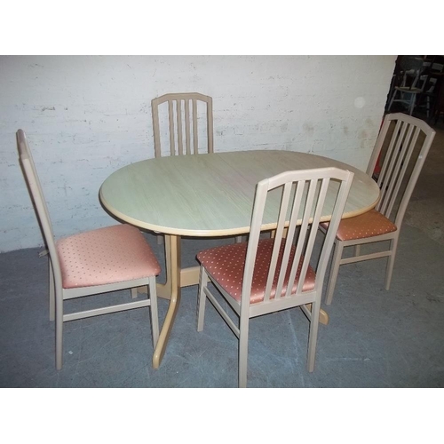 768 - AN EXTENDING BEAUTILITY DINING TABLE AND FOUR CHAIRS