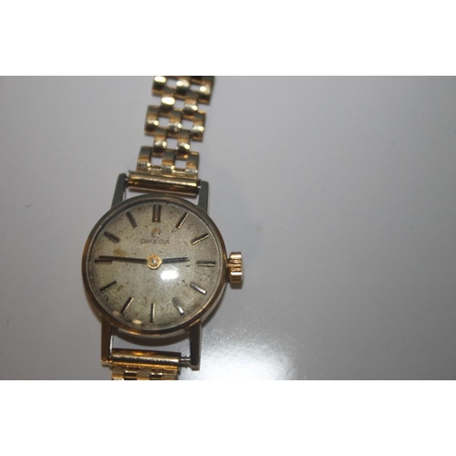 24 - A LADIES OMEGA MANUAL WIND WRIST WATCH on an unbranded 9 ct gold strap, dedication inscription to th... 