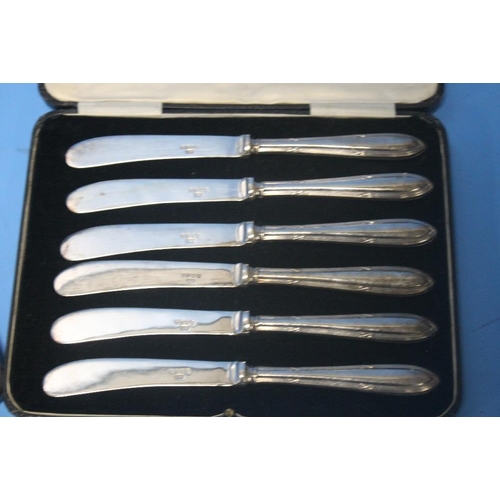 5 - TWO CASED SETS OF SILVER HANDLED KNIVES together with a cased set of white metal coffee bean spoons