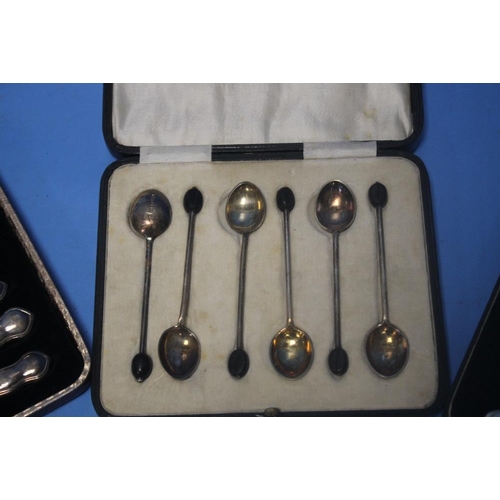 5 - TWO CASED SETS OF SILVER HANDLED KNIVES together with a cased set of white metal coffee bean spoons