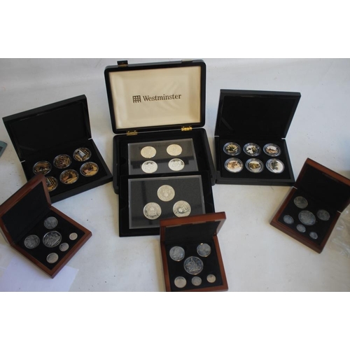 59 - A COLLECTION OF BOXED COMMEMORATIVE COINS, to include three Edward VIII retro sets, a set of St Hele... 