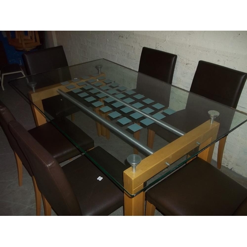 717 - A GLASS DINING SET WITH SIX FAUX LEATHER CHAIRS