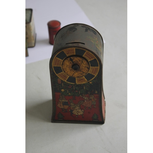 88 - A 'JACOB & CO.' BISCUIT TIN MONEY BOX with spinning wheel of fortune game and Christmas scenes on th... 