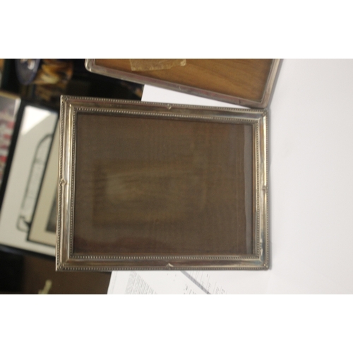 3 - TWO HALLMARKED SILVER PICTURE FRAMES together with a white metal frame, the largest 23 x 17.5 cm