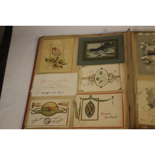 181 - AN EDWARDIAN SCRAP BOOK CONTAINING A COLLECTION OF GREETINGS CARDS, to include various dated example... 