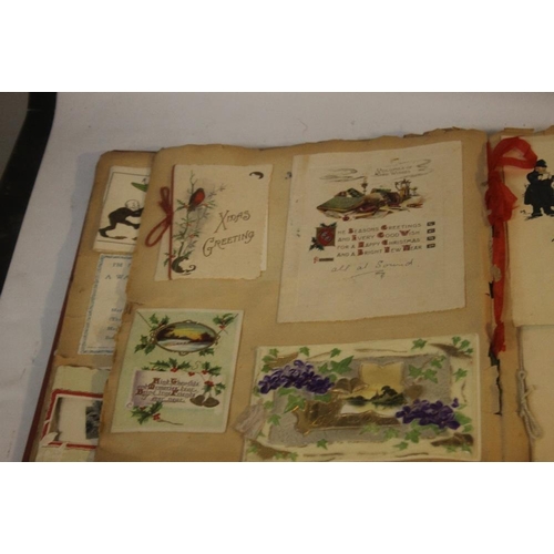 181 - AN EDWARDIAN SCRAP BOOK CONTAINING A COLLECTION OF GREETINGS CARDS, to include various dated example... 