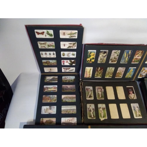 206 - A QUANTITY OF ALBUMS OF ASSORTED CIGARETTE CARDS, to include Film Stars, Military, Natural History e... 